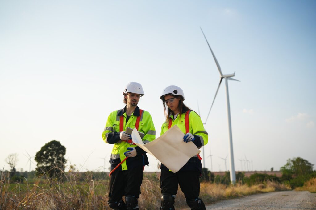 Sustainable energy industry - Engineers working at alternative renewable wind energy farm